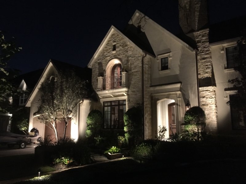 A beautiful home in Energy Corridor is illuminated with residential outdoor lighting.