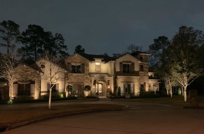 A memorial villages houston tx home with two stories lit up a night