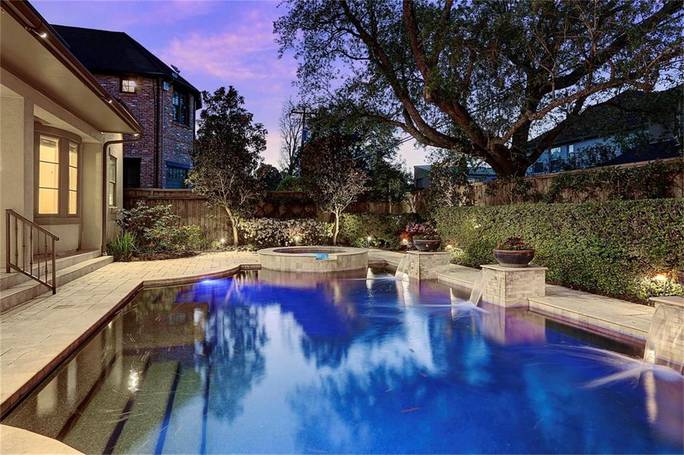 beautiful pool lighting ideas brought to life on a water feature under a purple sky