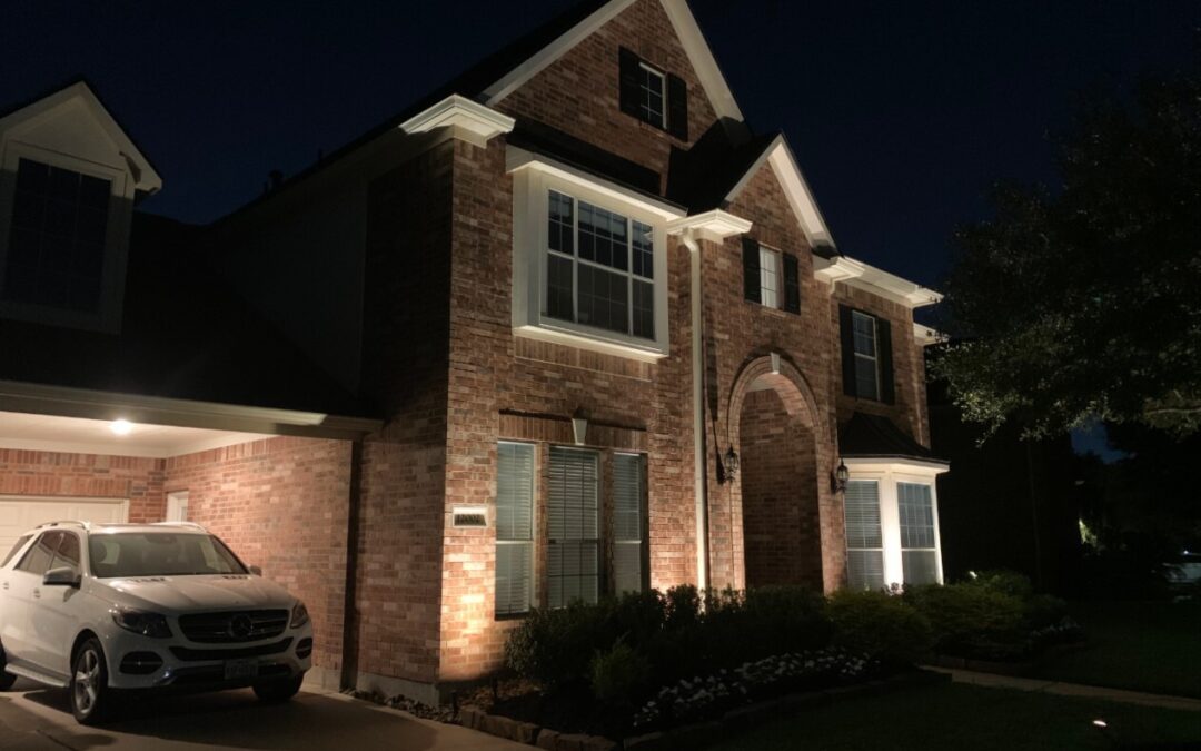 Houston Lightscapes retrofit lights in a two story brick house with a garage