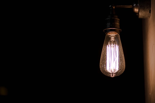 Single filament bulb illuminated at night