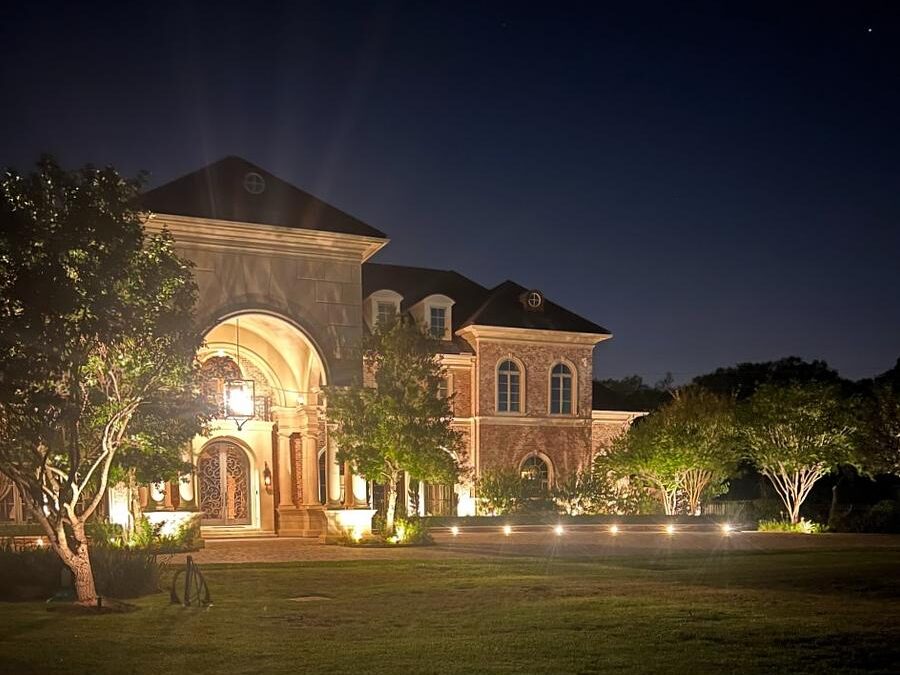 Landscape and driveway lighting leading up to large well it home will increase value
