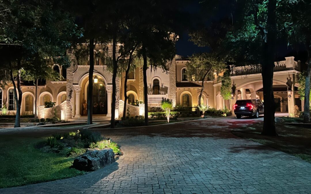 Large home and driveway with updated exterior lighting