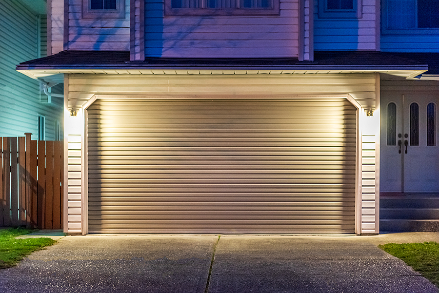 Garage door in luxury house in Vancouver, Canada. Exterior lighting placements