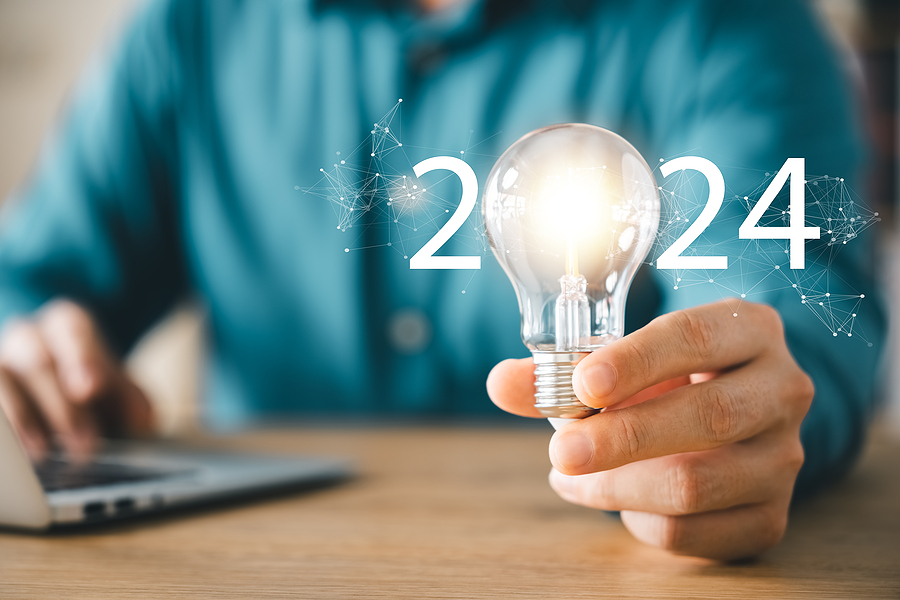 2024 creative concept, business man holding light bulb 2024 numbers, 2024 trend leader, setting goals for future business. Energy efficient