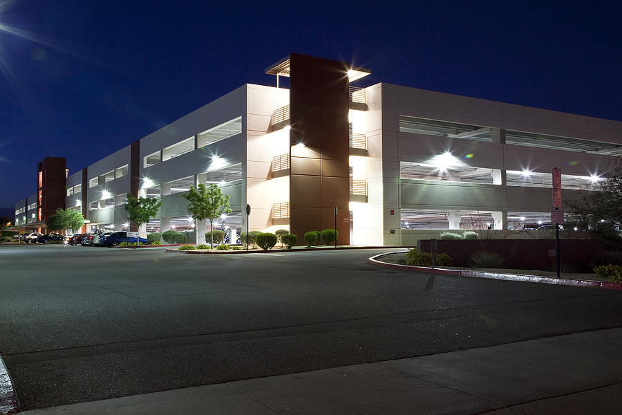 Well-lit parking garage at night, enhancing security by eliminating dark spots and improving visibility for pedestrians and vehicles.
